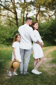 Pregnant woman with her family looking happy photo