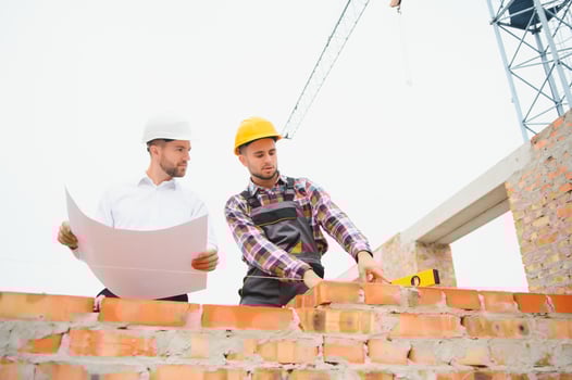 Builder and engineer on construction site photo
