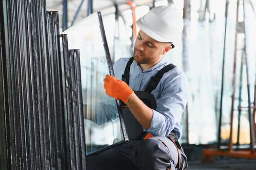 Workers transfer the glass. At the factory for the production of windows and doors of aluminum and PVC photo