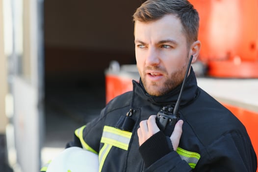 Fireman firefighter in action standing near a firetruck. Emergency safety. Protection, rescue from danger. photo