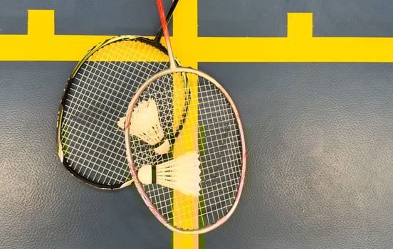 shuttlecock and badminton racket on the court photo