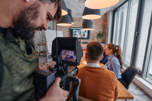 Capturing Corporate Dynamics. Videographer Films Business Meeting in Modern Office. photo
