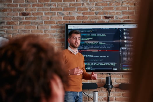 In a corporate setting businessman leads a meeting, passionately presenting a business plan to his attentive team, fostering collaboration and strategic thinking photo
