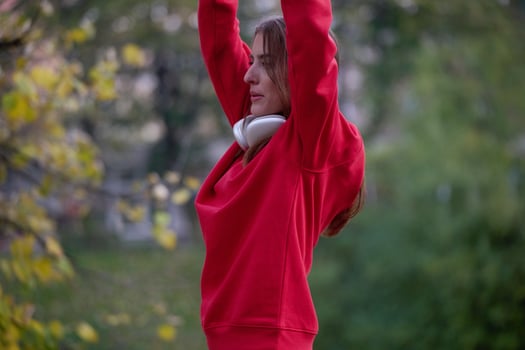 Athletic young woman taking a breath and relaxing after jogging and stretching. Woman Training and Workout Exercises On Street. photo