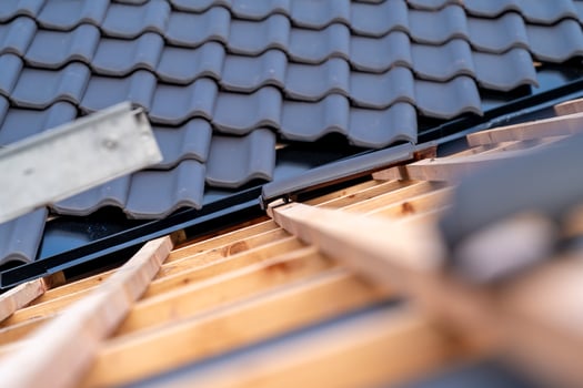 construction of the roof of a family house on wooden beams made of ceramic tiles photo