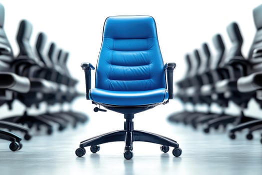 Blue office chair standing out from the crowd of black office chairs photo