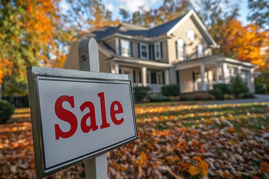 Sale sign announcing house for sale in front of suburban home in autumn photo