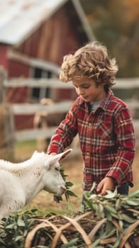 Boy feeding a goat with green leaves in a sunny garden photo