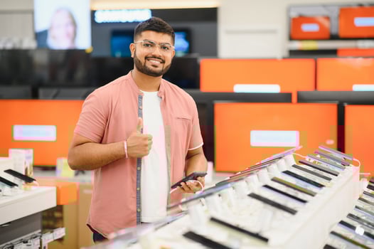 Indian man customer buyer at mobile phone store choose his new smartphone photo
