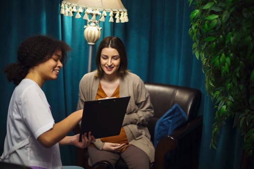 Happy young Caucasian pregnant woman talk consult with gynecologist in private clinic or hospital photo