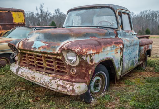 Abandoned old truck in a field photo