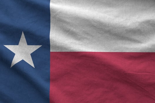 Texas US state flag depicted on folded wavy fabric of old cloth photo