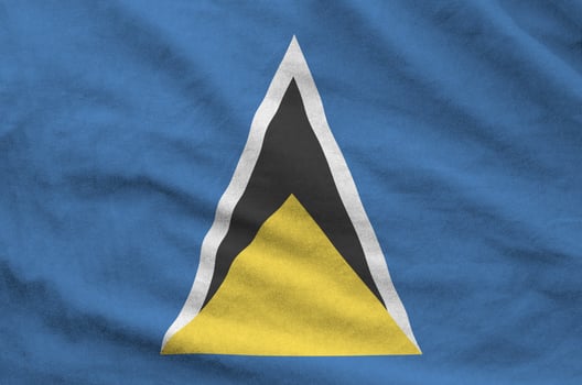 Saint Lucia flag depicted on folded wavy fabric of old cloth photo