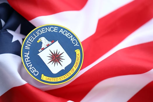 KYIV, UKRAINE - JUNE 26, 2024 United States of America Central Intelligence Agency coat of arms sticker on folded US flag photo