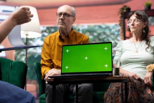 Social caretaker visiting elderly people patients at their home, using isolated mockup and doing a consultation to give treatment and vitamins for wellness. Nurse talking to old couple. photo