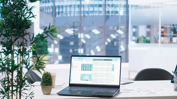 Laptop screen in office showing stock exchange indices changing in real time. Notebook in workspace with forex trading indexes displayed live showing latest price modifications photo