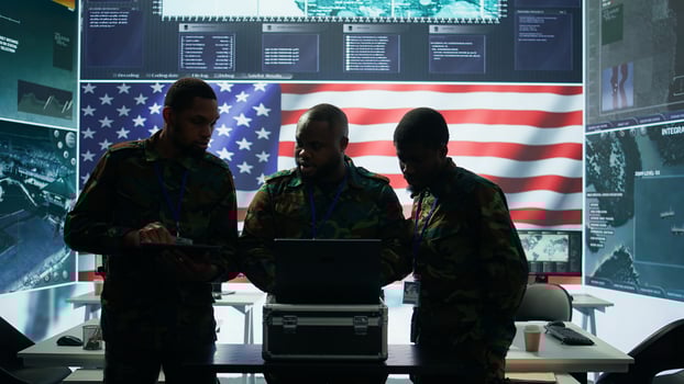 Military officer in a high tech control center engages in cybersecurity operations, protecting classified data from threats and managing digital warfare strategies to maintain state secrets. Camera B. photo