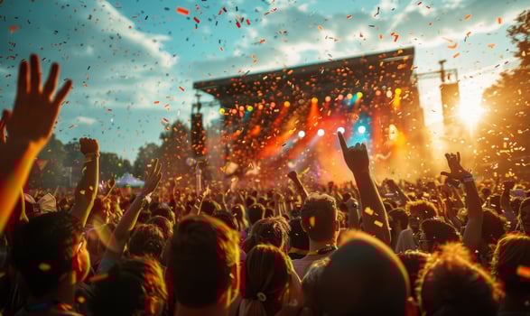 A lively outdoor music festival with a cheering crowd photo