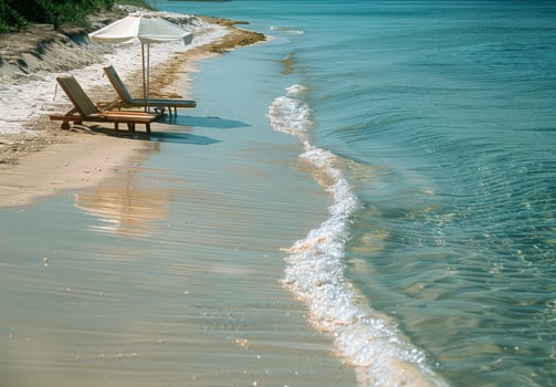 A serene beach scene with a beach chair and umbrella set up near the water's edge photo