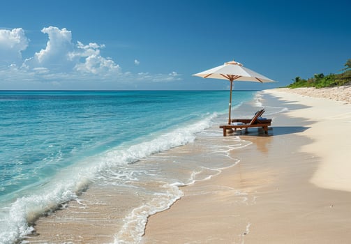 A serene beach scene with a beach chair and umbrella set up near the water's edge photo