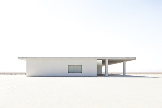 Minimalist white building in a desert landscape photo