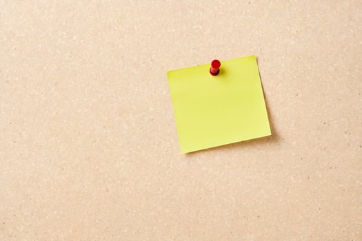 Blank Yellow Sticky Note on Corkboard photo