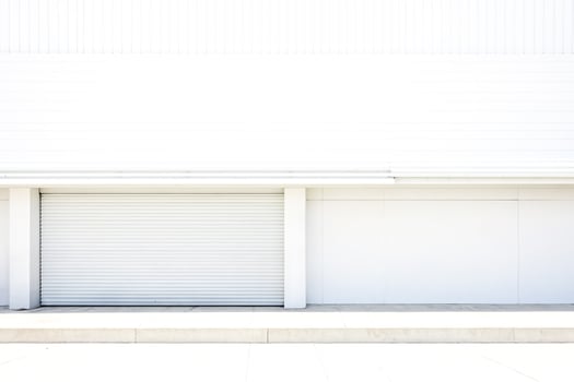 White Concrete Wall with Garage Door and Step photo