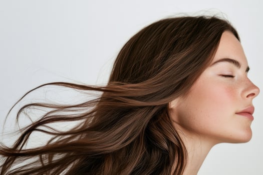 Elegant brunette profile with flowing hair. photo