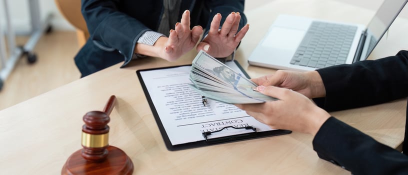 Lawyer Accepting Bribe Money for Corruption in Office Setting with Contract and Gavel on Desk photo
