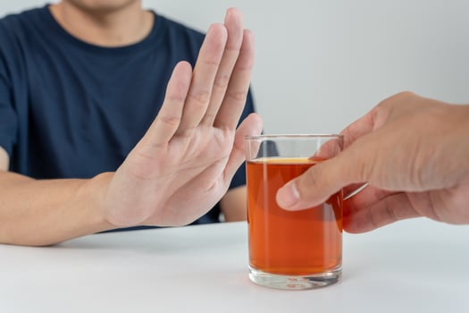 man refuses say no and avoid to drink an alcohol whiskey , stopping hand sign male, alcoholism treatment, alcohol addiction, quit booze, Stop Drinking Alcohol. Refuse Glass liquor, unhealthy, reject photo