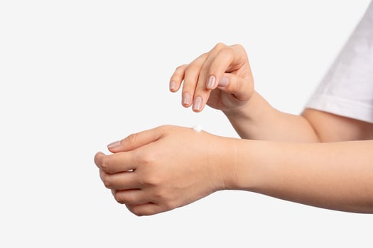 Female applying cream to her hands . photo