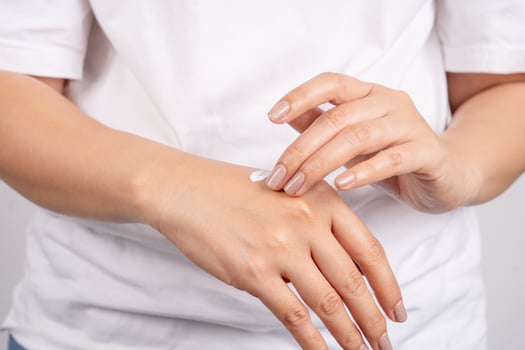 Female model applying moisturizing products to the skin for skin health or moisture. photo