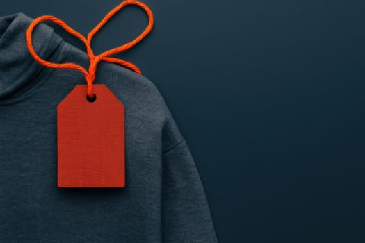 A sale tag on a piece of athletic wear, capturing sportswear discounts photo
