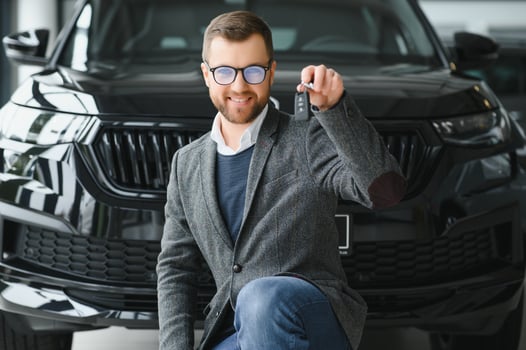 Young man with the keys at the car photo