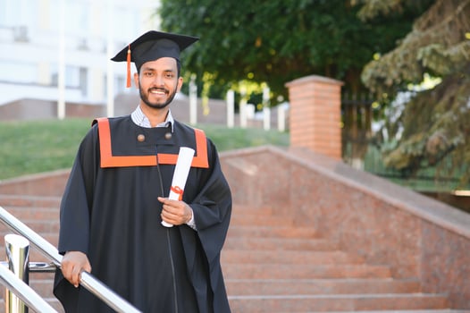 Young indian graduated boy holding his graduation degree convocation ceremony. student graduate posing. photo