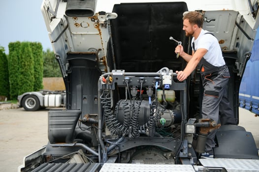 Professional truck mechanic working in vehicle repair service. photo