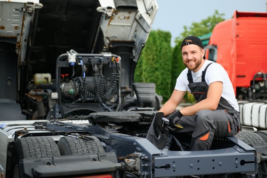 Professional truck mechanic working in vehicle repair service. photo