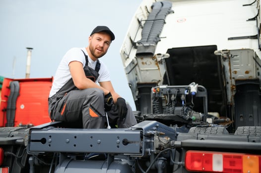 Professional truck mechanic working in vehicle repair service. photo