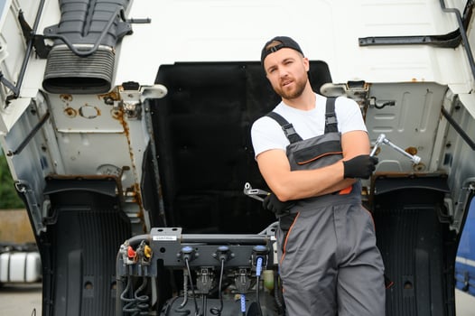 Professional truck mechanic working in vehicle repair service. photo