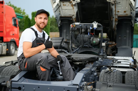 Semi Truck Maintenance. Caucasian Truck Service Worker in His 30s Performing Scheduled Recall Maintenance. photo