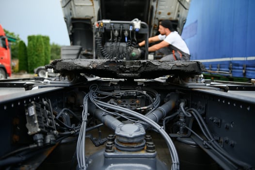 Professional truck mechanic working in vehicle repair service. photo