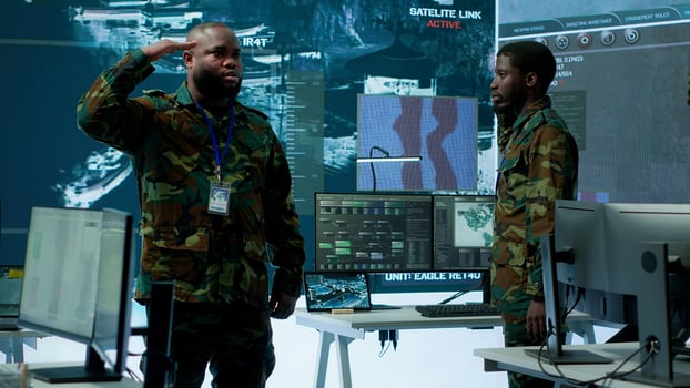 Military personnel operate advanced systems in a command center, focusing on surveillance and data analysis to protect national security. Soldiers trained to manage information warfare. Camera A. photo