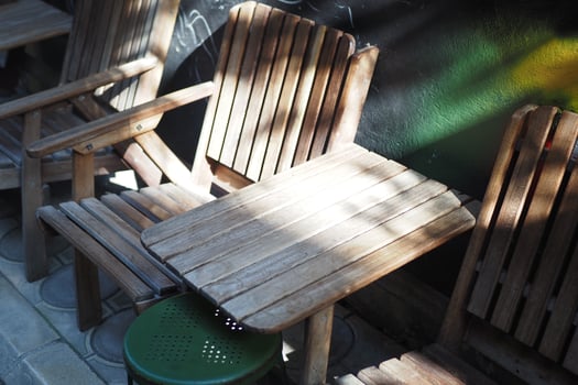 Stylish wooden chairs and a table create a charming outdoor setting for relaxation and socializing photo
