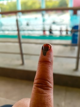 Young voter showing her ink-marked fingers after casting votes near polling booth of east Delhi, India for general Lok Sabha Elections 2024 photo