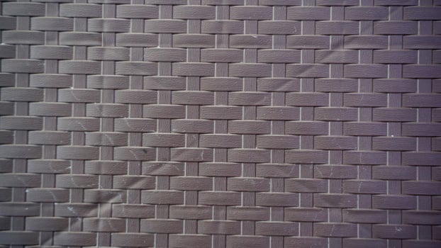 Brick wall texture background. Brown flat pattern of synthetic rattan material made from plastic. photo