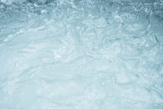 Turbulent water surface with visible foam and ripples. photo