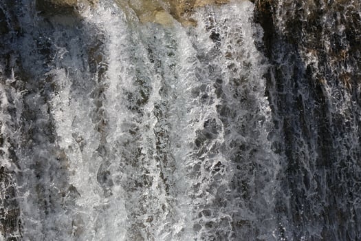 Pouring a beautiful waterfall in the moment with the visible suspended water particles photo