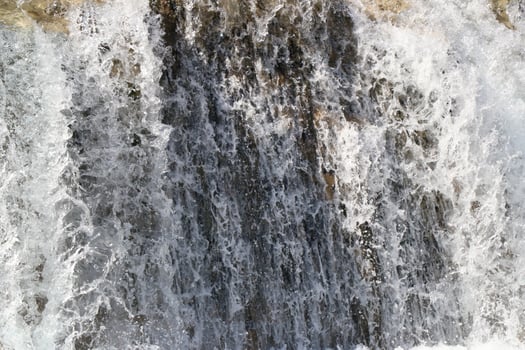Pouring a beautiful waterfall in the moment with the visible suspended water particles photo
