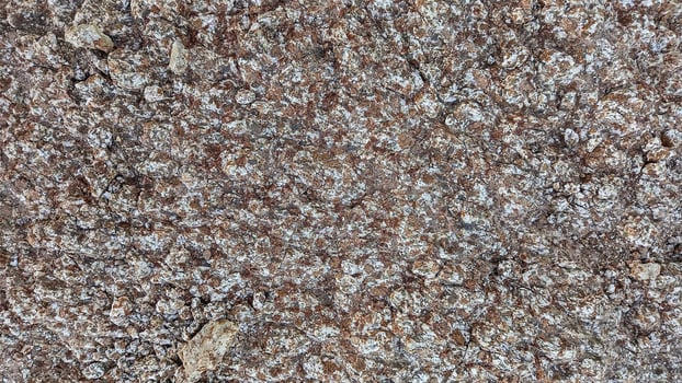 Rough, grey, dark harsh and high contrast granite stone texture background. A close-up of the surface of abstract natural rock. Natural Marble stone wallpaper. photo
