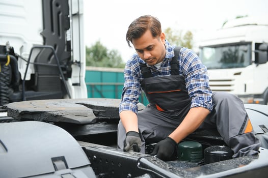 Indian Mechanic repairing the truck photo